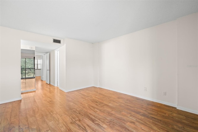 unfurnished room with hardwood / wood-style flooring