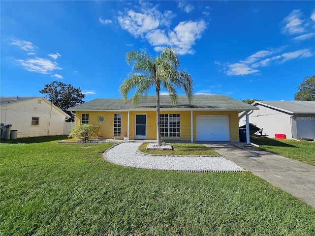 single story home featuring a garage and a front lawn