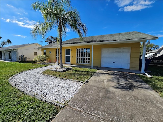 3141 Ludlow Dr, New Port Richey, FL 34655 - ranch-style home featuring asphalt driveway, a front yard, and an attached garage