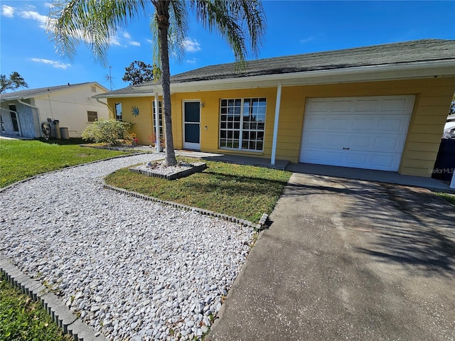 ranch-style house with a front yard and a garage