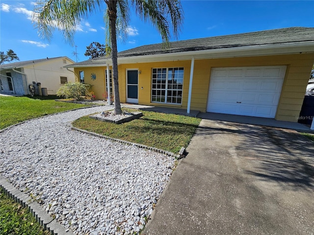 3141 Ludlow Dr, New Port Richey, FL 34655 - single story home with asphalt driveway, a front yard, and a garage