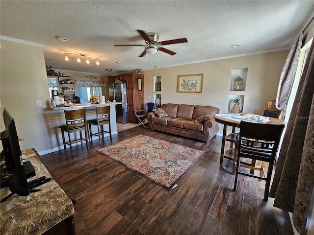 living room featuring ornamental molding, a textured ceiling, ceiling fan, and dark wood-type flooring