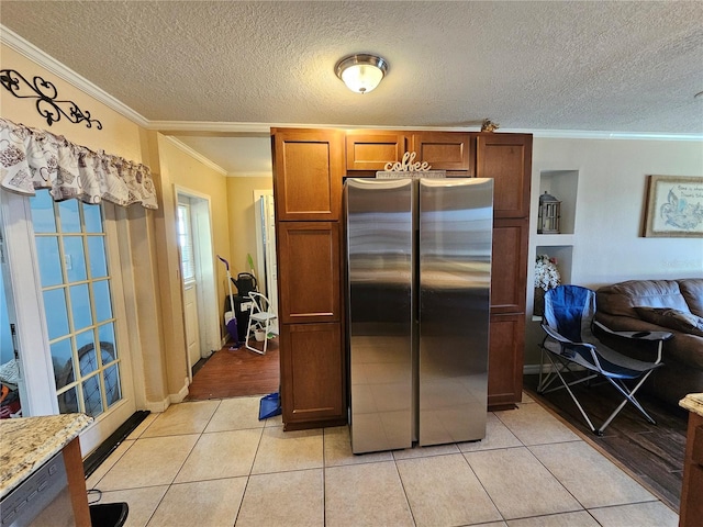 3141 Ludlow Dr, New Port Richey, FL 34655 - kitchen featuring freestanding refrigerator, ornamental molding, light tile patterned flooring, a textured ceiling, and open floor plan