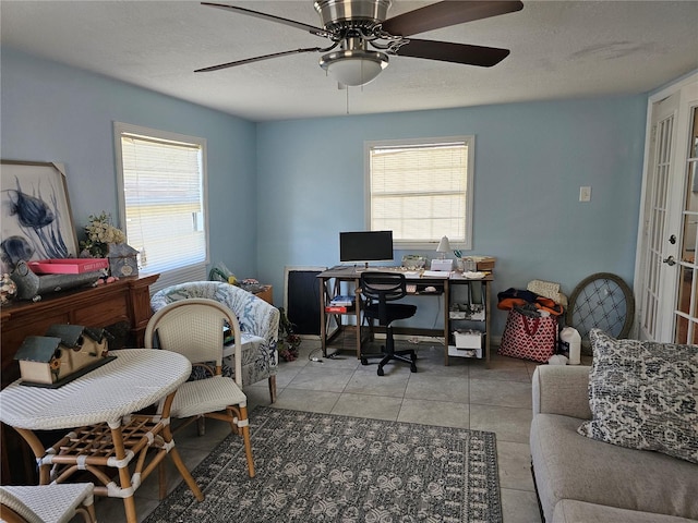 office featuring tile patterned flooring, ceiling fan, a textured ceiling, and a wealth of natural light