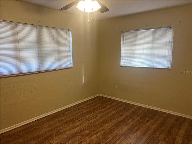 empty room featuring dark hardwood / wood-style floors and ceiling fan