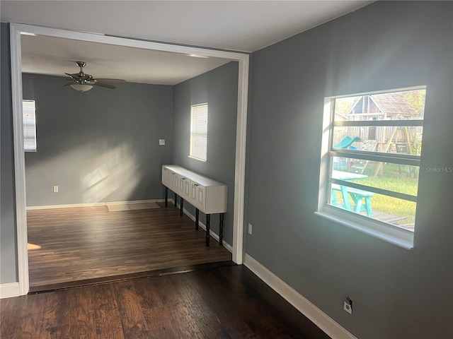 unfurnished room with dark hardwood / wood-style flooring and ceiling fan