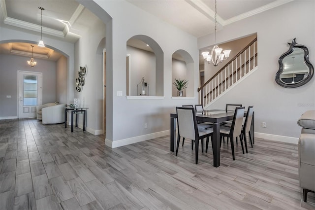 dining space with a chandelier, light hardwood / wood-style flooring, and ornamental molding