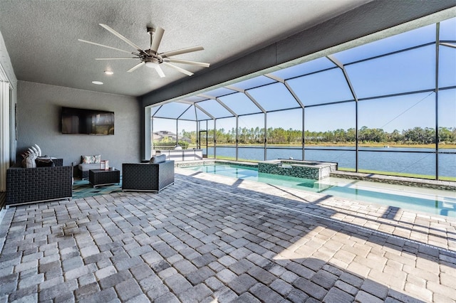 view of pool featuring glass enclosure, an in ground hot tub, ceiling fan, and an outdoor living space