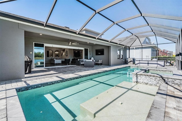 view of swimming pool with glass enclosure, ceiling fan, an outdoor hangout area, a patio area, and an in ground hot tub