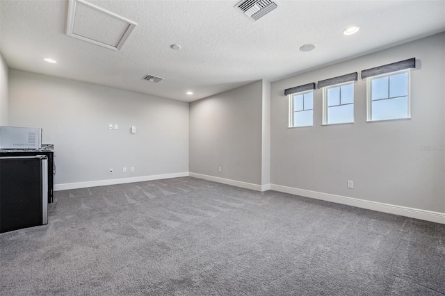 interior space with carpet floors and a textured ceiling