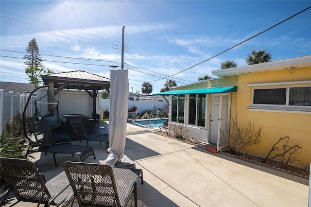 view of patio with a fenced in pool and a gazebo