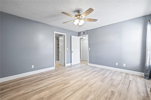 unfurnished bedroom with visible vents, ceiling fan, a textured ceiling, light wood-type flooring, and baseboards