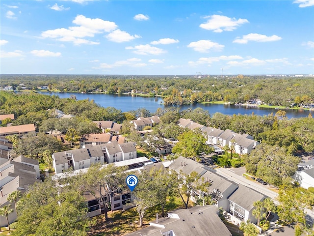 birds eye view of property featuring a forest view, a water view, and a residential view