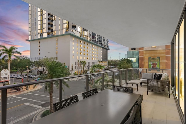 balcony at dusk featuring outdoor lounge area