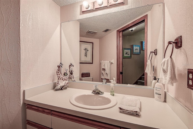 bathroom with vanity and a textured ceiling