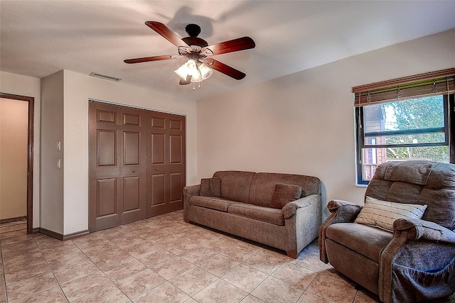 living room featuring ceiling fan and light tile patterned floors