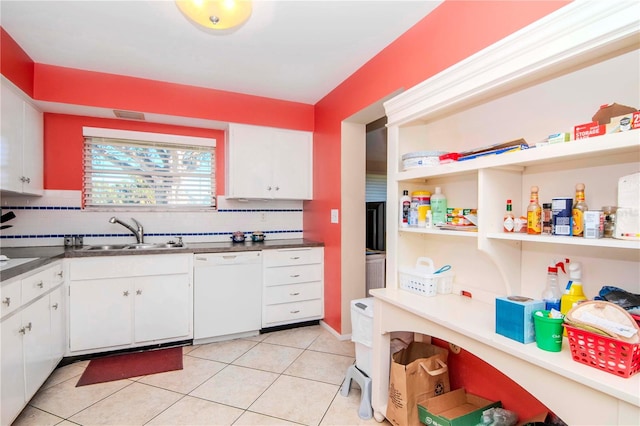 kitchen with backsplash, white dishwasher, sink, light tile patterned floors, and white cabinetry