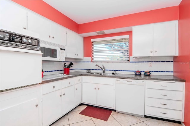 kitchen with decorative backsplash, sink, white cabinets, and white appliances