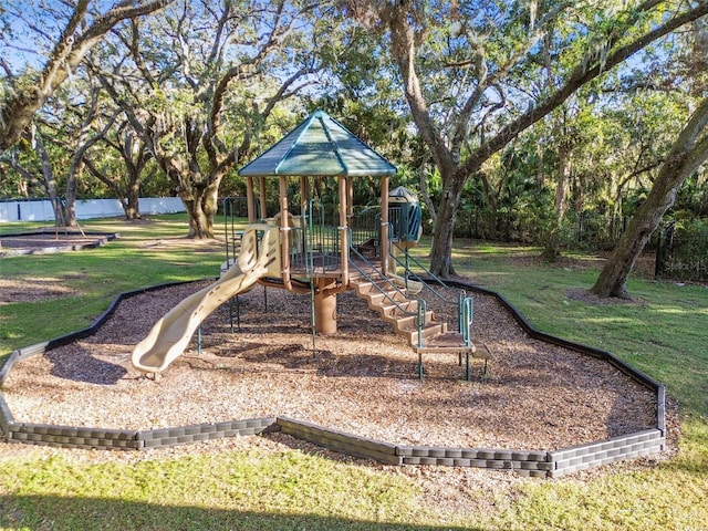 view of jungle gym with a lawn