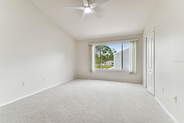 unfurnished room with ceiling fan, vaulted ceiling, and light carpet