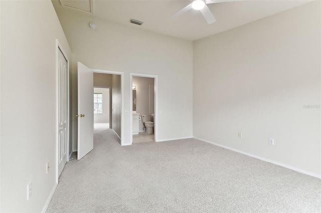 carpeted spare room featuring ceiling fan