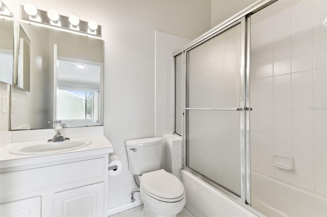 full bathroom featuring enclosed tub / shower combo, vanity, and toilet