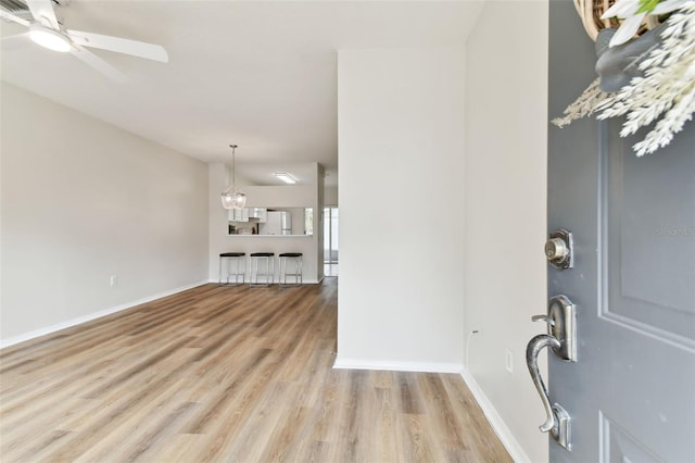 foyer featuring ceiling fan and light hardwood / wood-style flooring