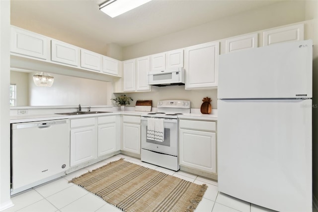 kitchen with white cabinetry, sink, white appliances, light tile patterned floors, and an inviting chandelier