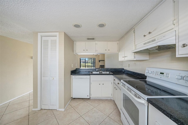 kitchen featuring white appliances, light tile patterned floors, sink, and white cabinets