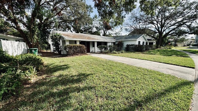 ranch-style home featuring a front yard