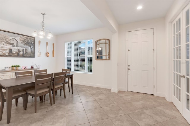 dining room with light tile patterned flooring and an inviting chandelier