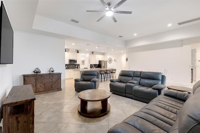 living room featuring ceiling fan and light tile patterned floors