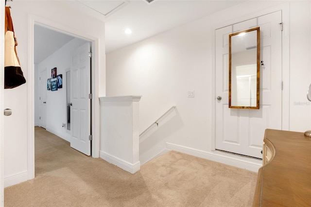 hallway featuring light colored carpet