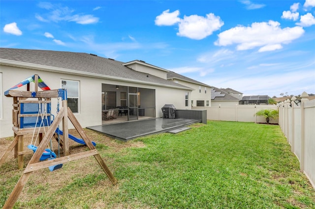 back of property featuring a patio, a playground, and a yard