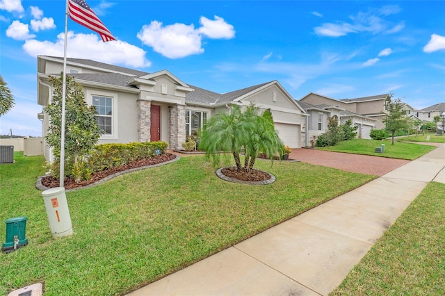 ranch-style home featuring central AC unit, a front yard, and a garage