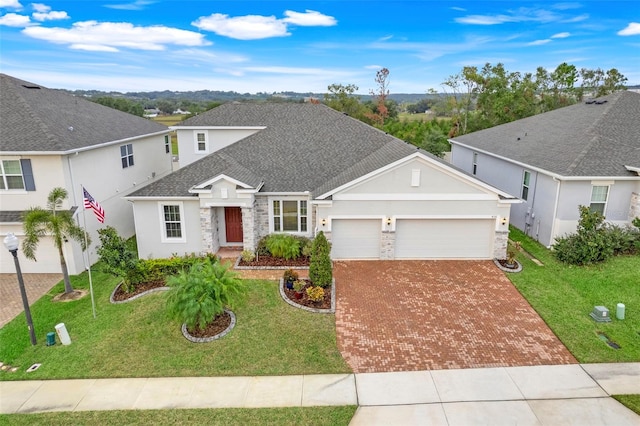 view of front of home with a front yard and a garage