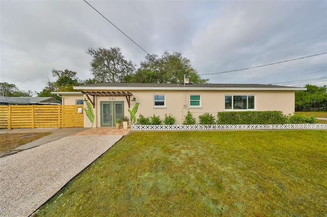 ranch-style home with a front lawn