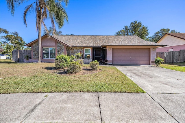 single story home featuring a garage and a front lawn