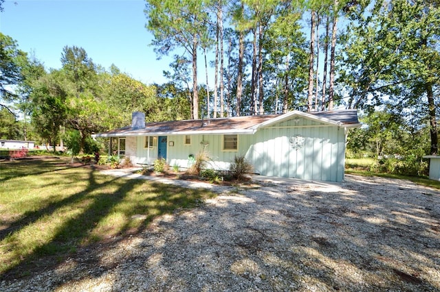 ranch-style house with a front yard and covered porch