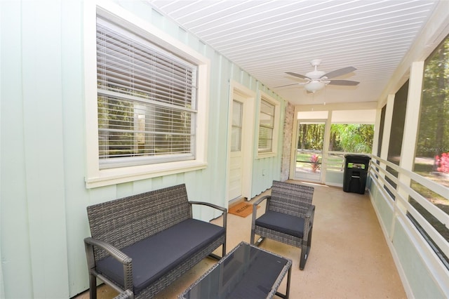 sunroom / solarium featuring ceiling fan