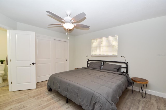 bedroom featuring ceiling fan, light hardwood / wood-style floors, connected bathroom, and a closet