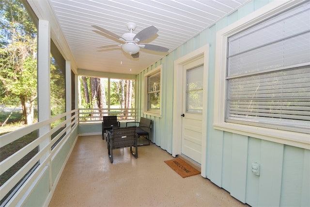 sunroom / solarium featuring ceiling fan