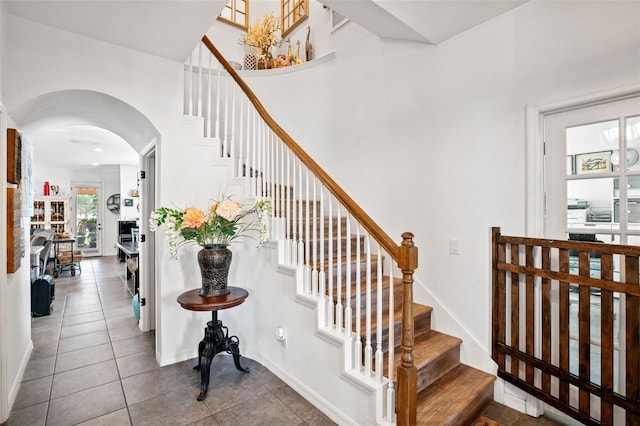 staircase featuring tile patterned floors