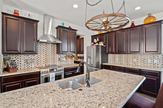 kitchen featuring backsplash, sink, wall chimney exhaust hood, and appliances with stainless steel finishes