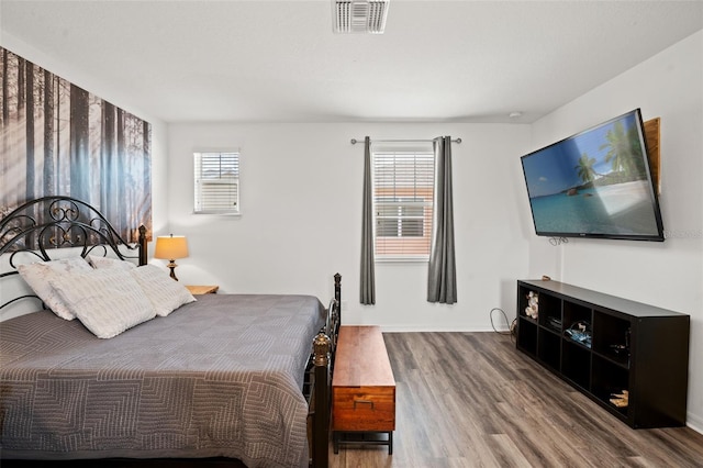 bedroom featuring hardwood / wood-style floors and multiple windows