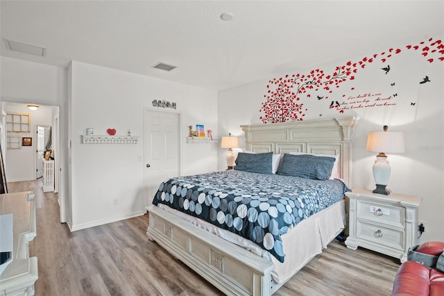 bedroom with light hardwood / wood-style flooring