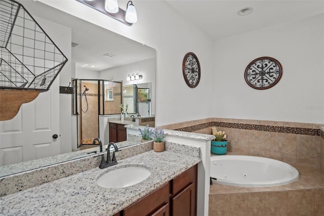 bathroom featuring vanity and shower with separate bathtub