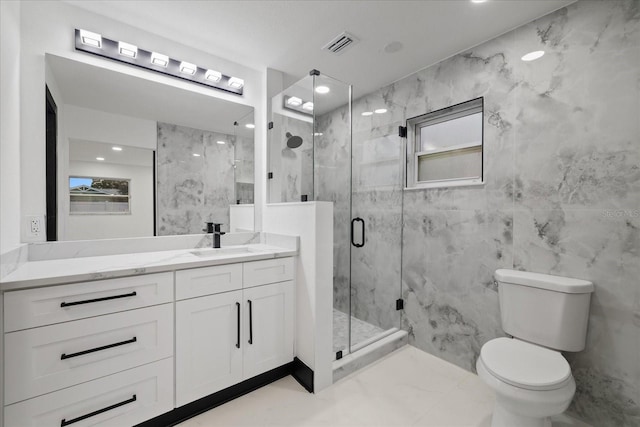 bathroom featuring toilet, a shower with door, and vanity