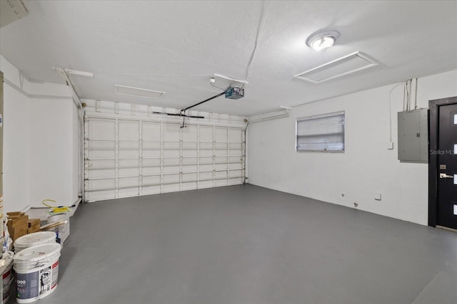 garage featuring a garage door opener and electric panel