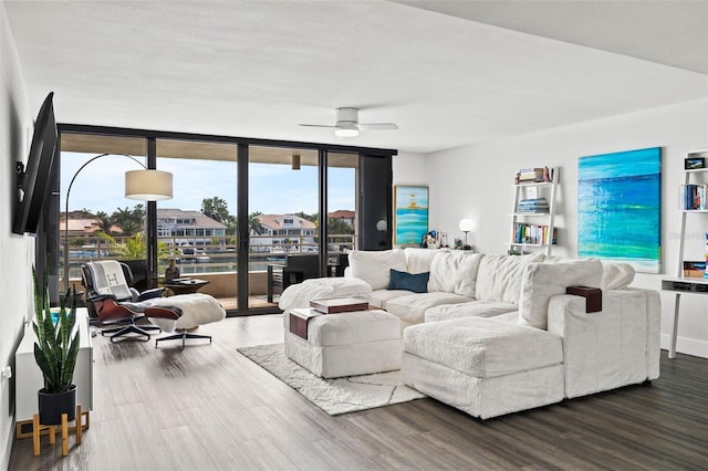 living room featuring hardwood / wood-style floors, ceiling fan, and expansive windows